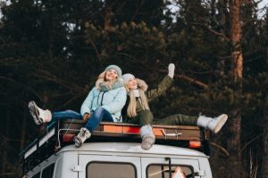 TwoGirlsInWinterClothesAreSittingOnTheRoof - Meineke Chicago Vehicle Maintenance | Meineke Car Care | Des Plaines, IL