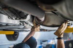MechanicInspectingVehiclesCatalyticConverterDuringScheduledCarExhaustSystem - Meineke Chicago Meineke Car Care | Catalytic Converter