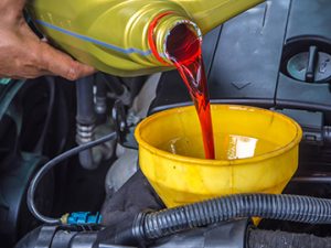 HandFillUpInACarEngineWithTransmissionOil - Meineke Chicago Meineke Car Care | Transmission Fluid | Oak Park